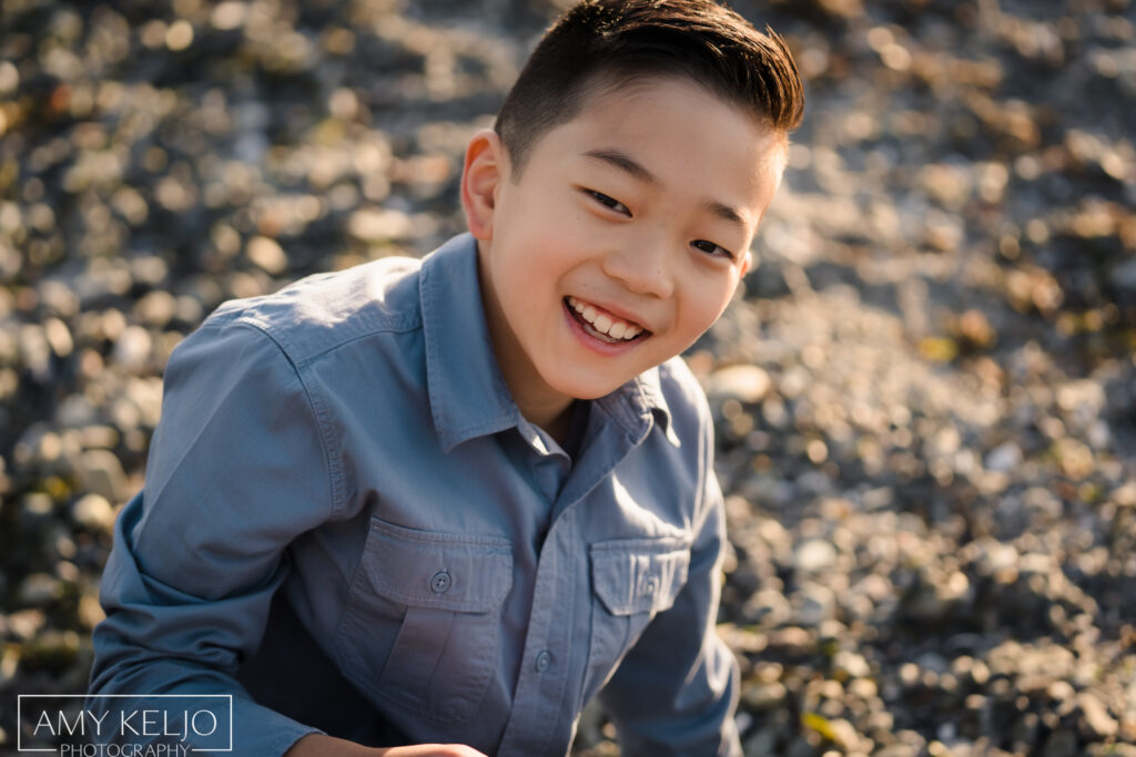 Young boy on beach at Carkeek Park in Seattle
