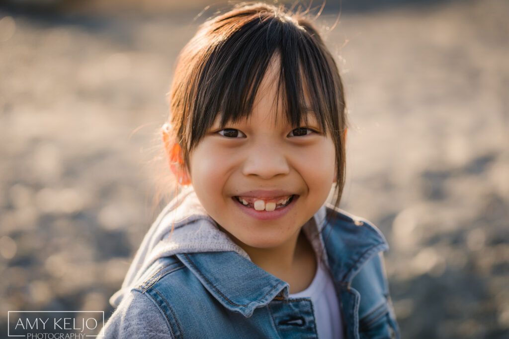 Young girl on beach at Carkeek Park in Seattle