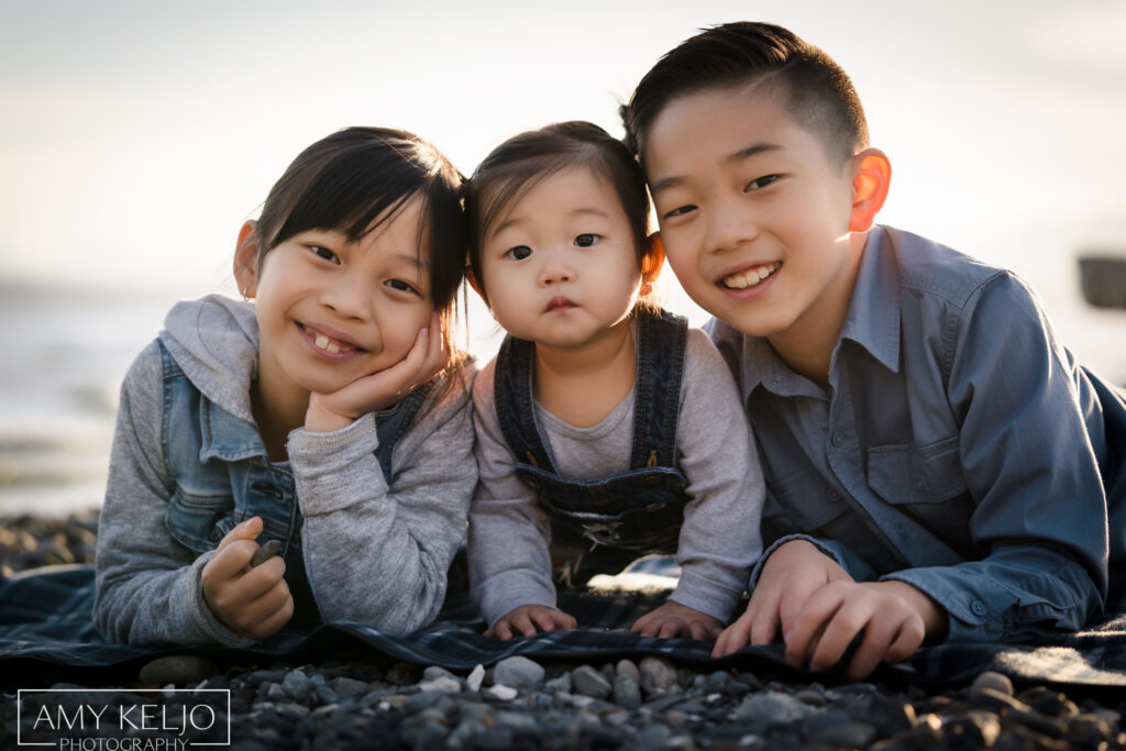 Young siblings on beach at Carkeek Park in Seattle