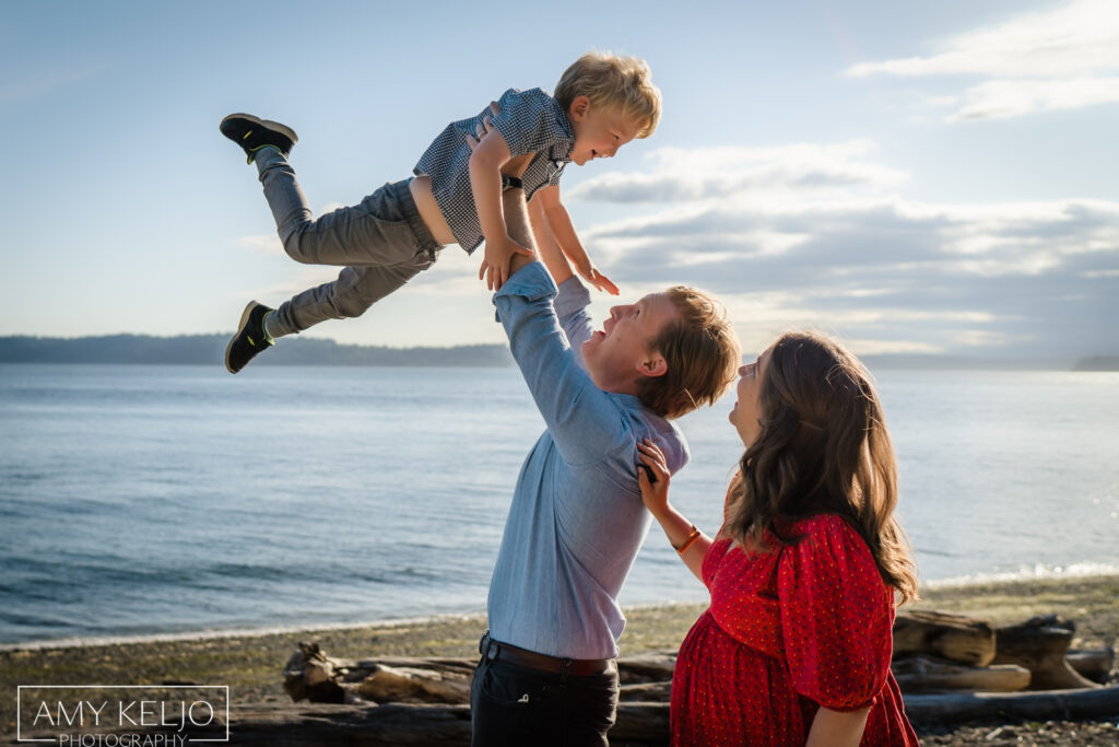 Father throwing son over his head in a lifestyle photo shoot in Seattle