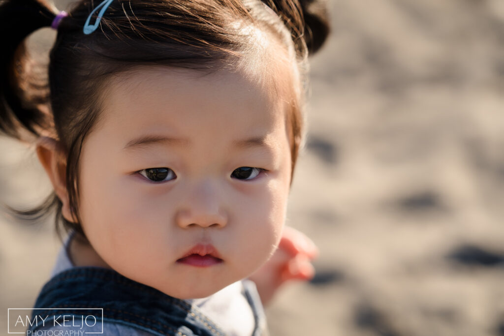 Baby girl close up photograph on beach at Carkeek Park in Seattle