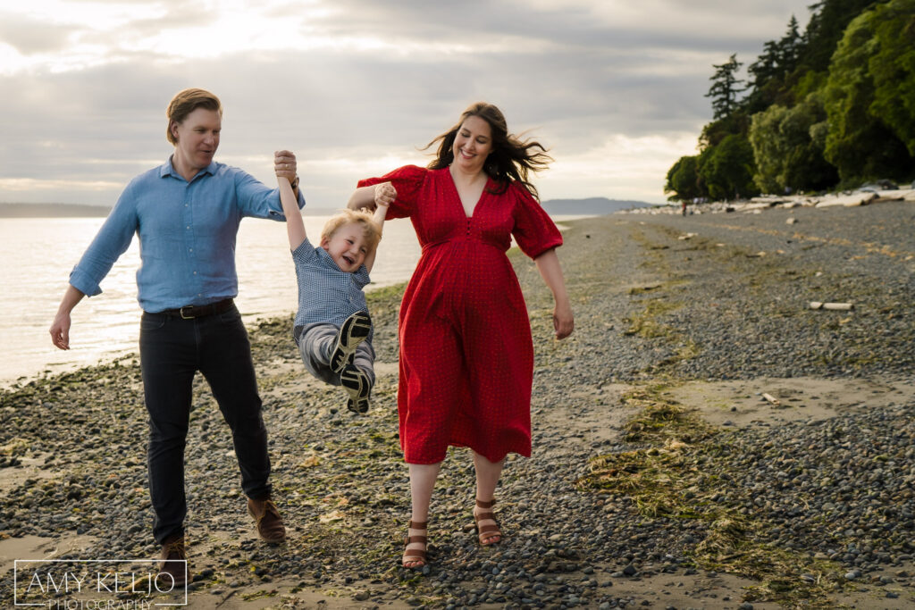 Family playing on beach at Lincoln Park in Seattle