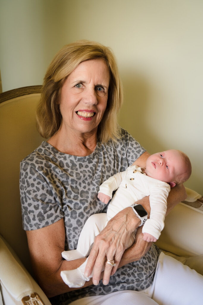 Grandmother holding her newborn grandchild at home photoshoot in Seattle